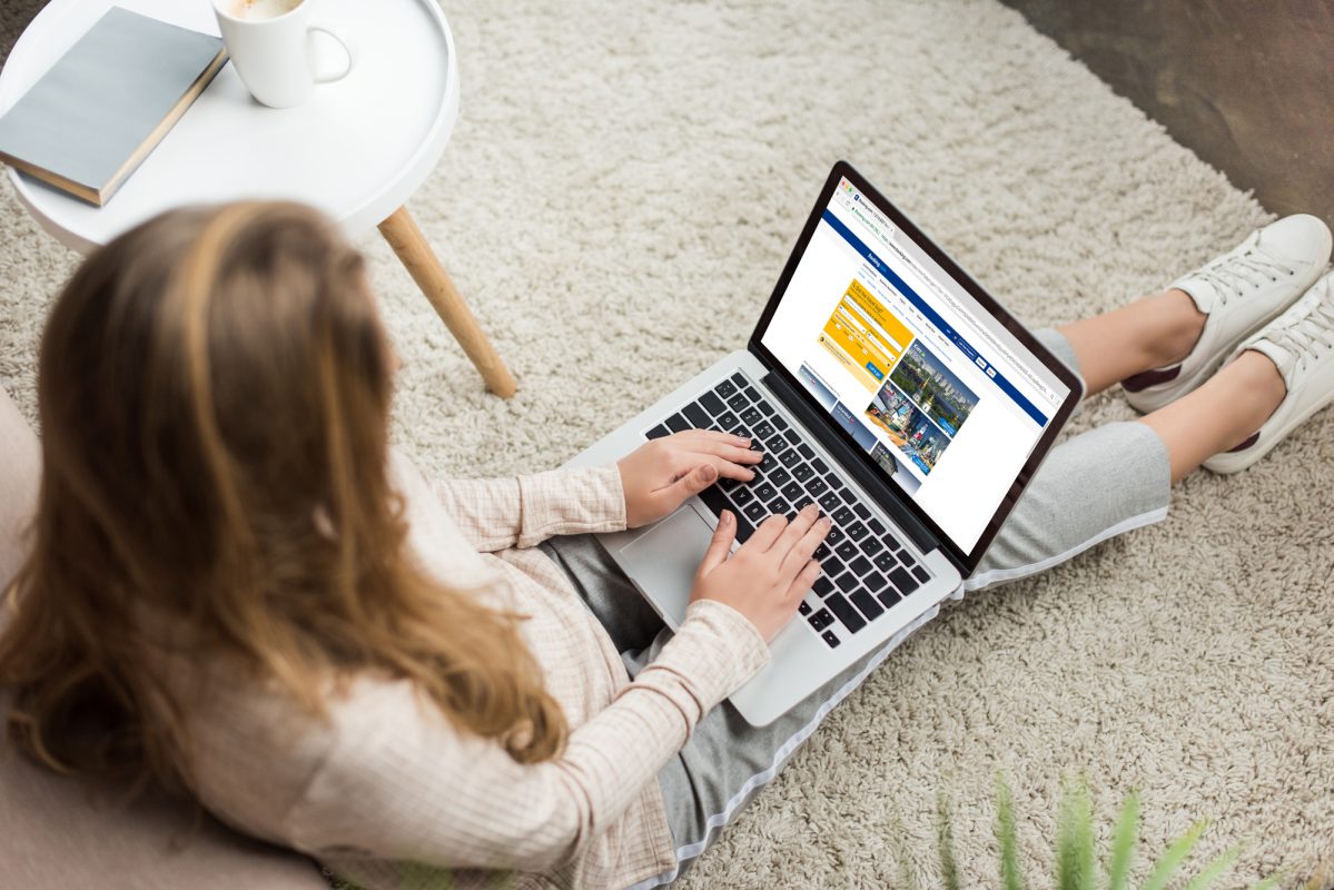Girl On Computer Sitting On Carpet