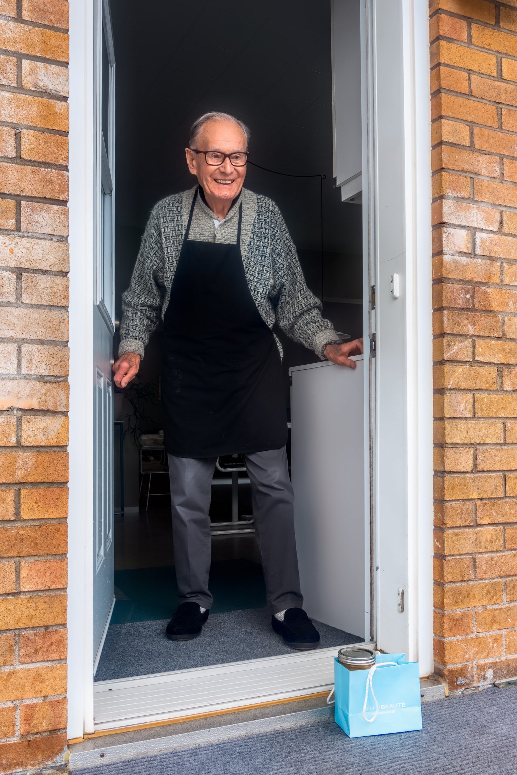 Happy Old Man Standing In Doorway Parkinson