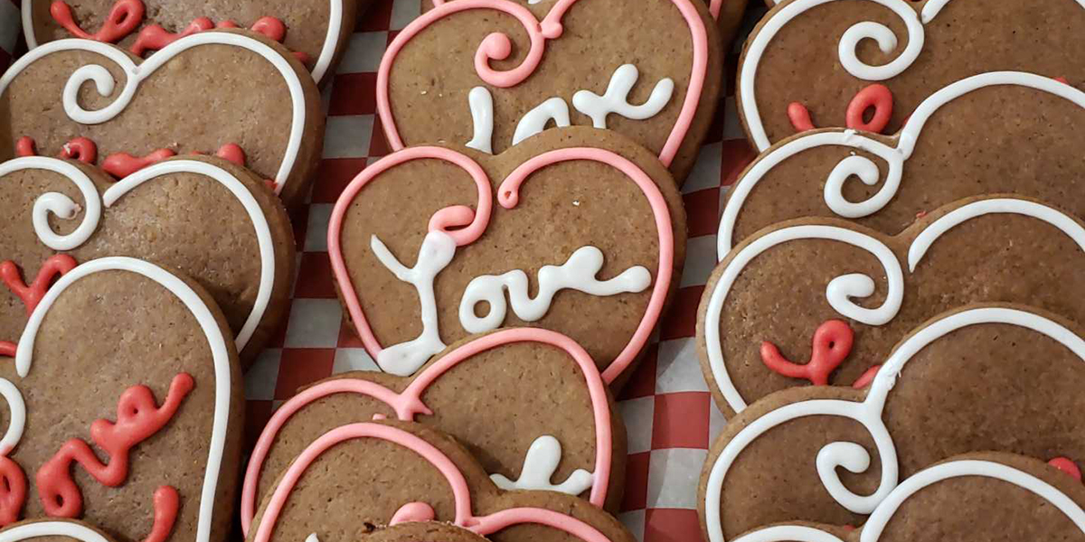 Heart cookies iced with "Love" written on them from The Cake Lady German Bakery