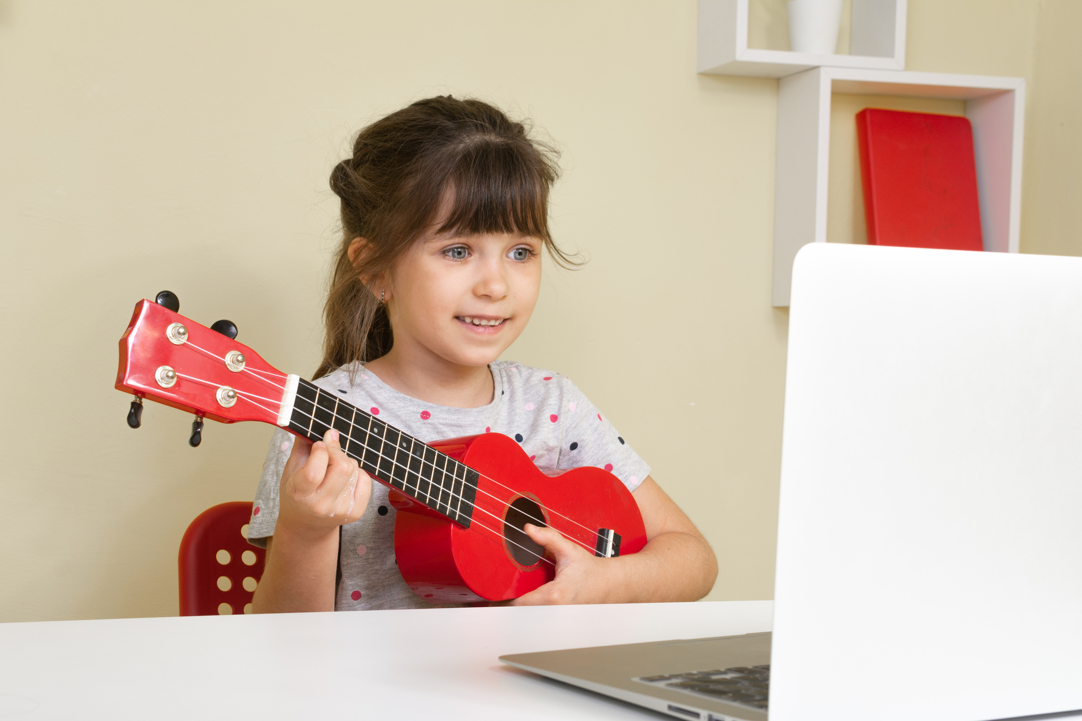 little girl taking online ukulele music lessonsu