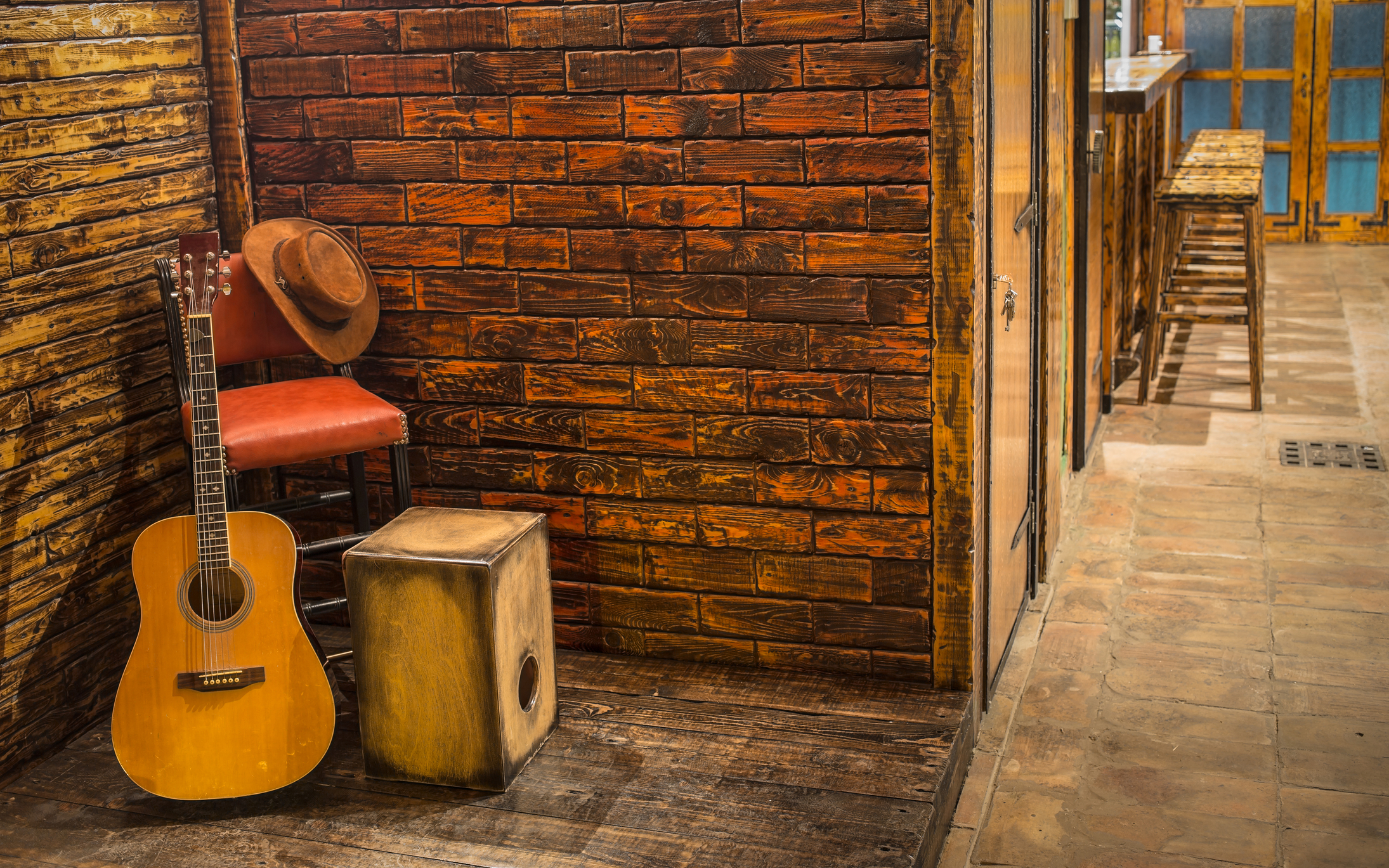 SL image Side Door Empty Stage with guitar, cowboy hat, and stool. Live Shows